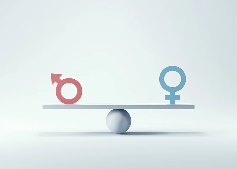 Balanza equilibrada con el icono de sexo femenino y masculino